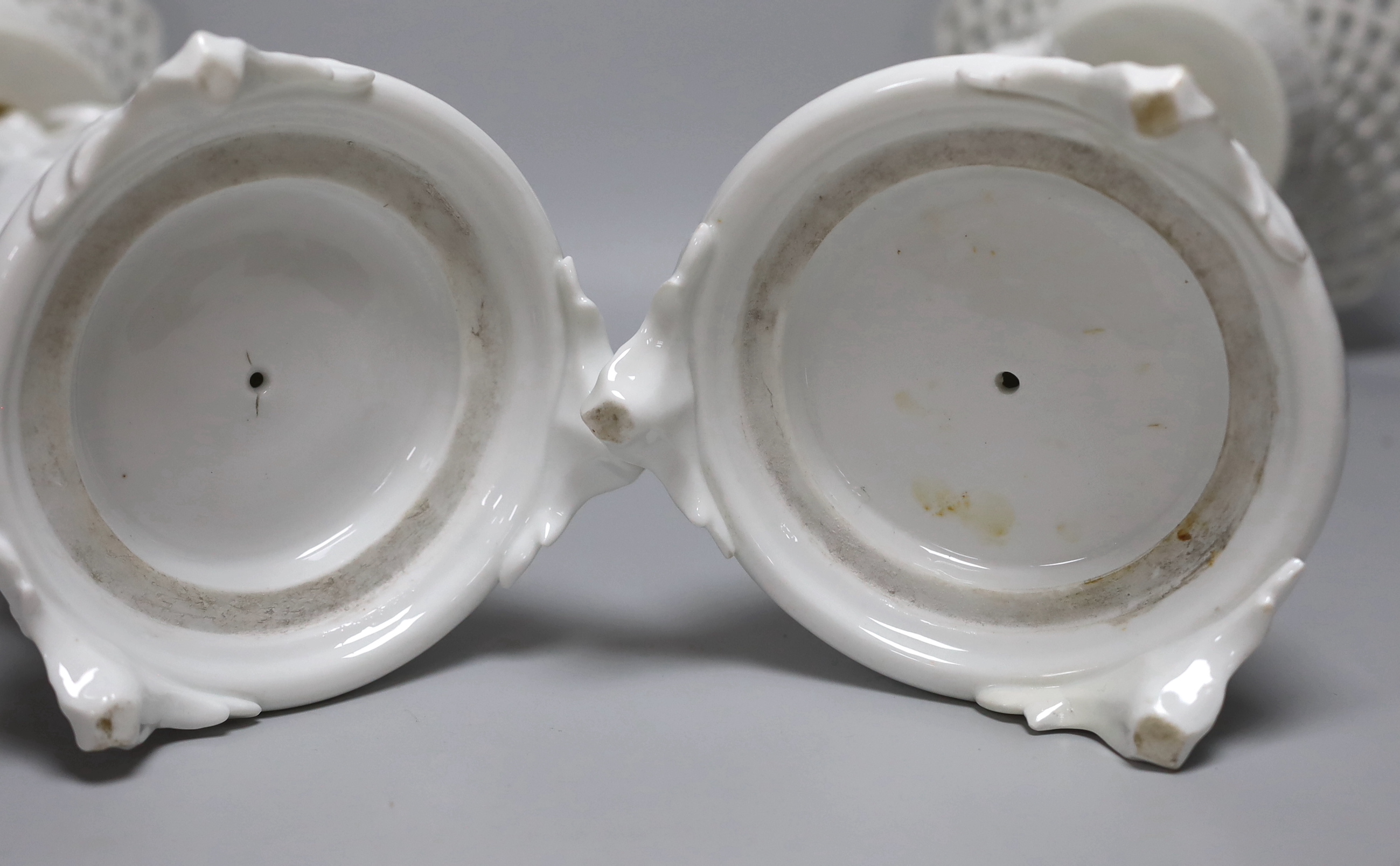 A pair of Paris porcelain figural comports or centre pieces with lattice work baskets, each 38cm high